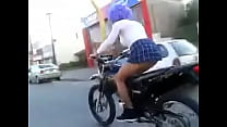 little bitch rides a motorcycle showing her tail