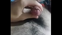 Hairy young guy jerking off and cumming on the stomach