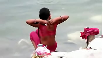 Indian woman bathing in ganges river backless open