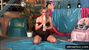 Voluptuous blonde teasing big tits with a dildo