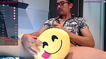 A shy young man masturbates placing a pillow in front of him so they can't see his huge cock, he doesn't realize that his big bright pink head of penis is reaching up to look beautiful.