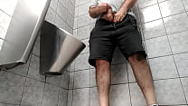A busy guy with an uncut dick peeing in a public toilet