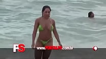 Melon woman pays breast on the beach
