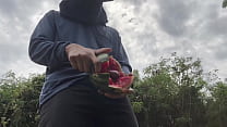 Worker cum with watermelon.